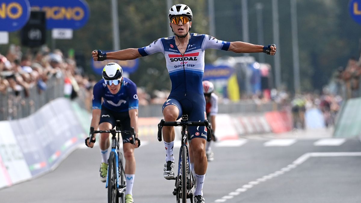 Andrea Bagioli (C), celebrates winning the Gran Piemonte, crossing the line dressed in blue and white lyrca.