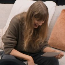 Taylor Swift reading a letter from Travis Kelce in episode six of her docuseries, The End of an Era.