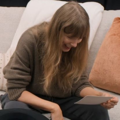 Taylor Swift reading a letter from Travis Kelce in episode six of her docuseries, The End of an Era.