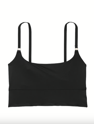 a black sports bra by victoria's secret in front of a plain backdrop