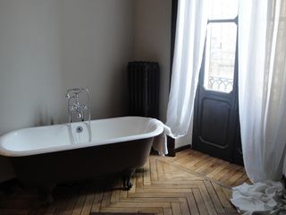 Bathroom with bathtub and wood texture flooring