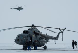 Russian MI-8 helicopters are seen at the Karanganda Airport shortly after poor weather forced the fleet of 12 helicopters to turn around from their flight to Zhezkazgan, Kazakhstan where they were to have pre-staged for the landing of the Soyuz TMA-10M sp