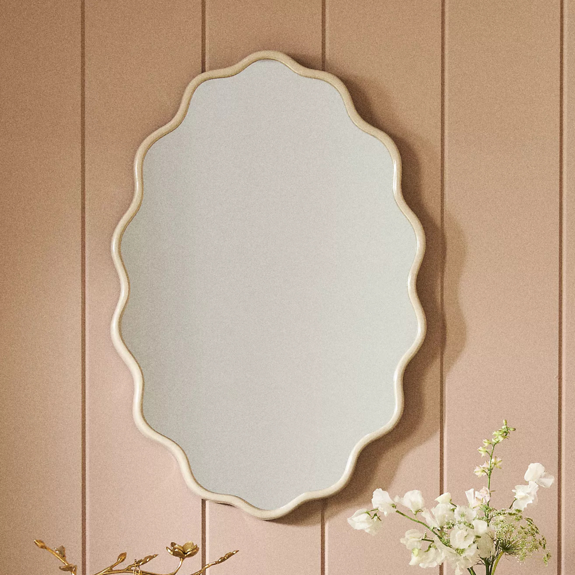 A wavy mirror with a beige frame from Anthropologie