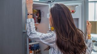 Woman looking for food in fridge