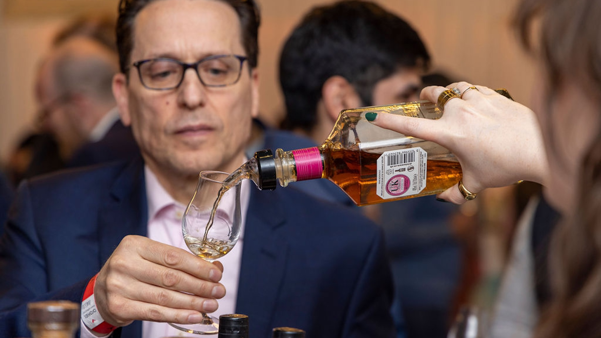 Welcome to Whisky- whisky being poured into a glass 