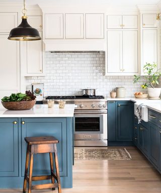 Shaker style kitchen with blue base cabinets and white wall cabinets, photograph Joyelle West