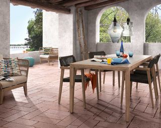 enclosed greek style patio with dining table and chairs form Cuckooland