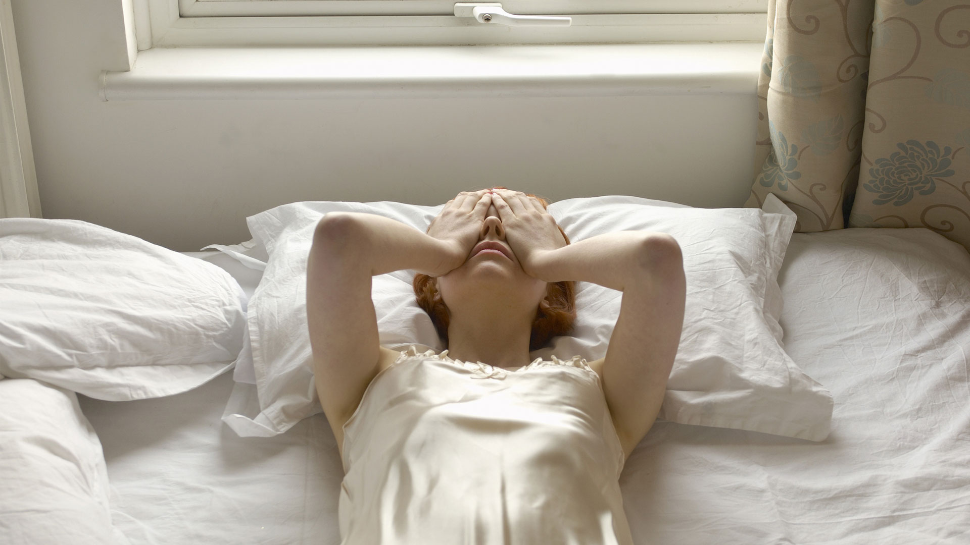 Can you use massage for headache relief ?image shows woman in bed