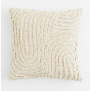 cream pillow with a tufted pattern