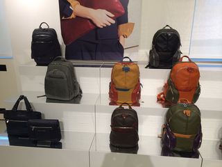 A display of colourful backpacks on tiled steps