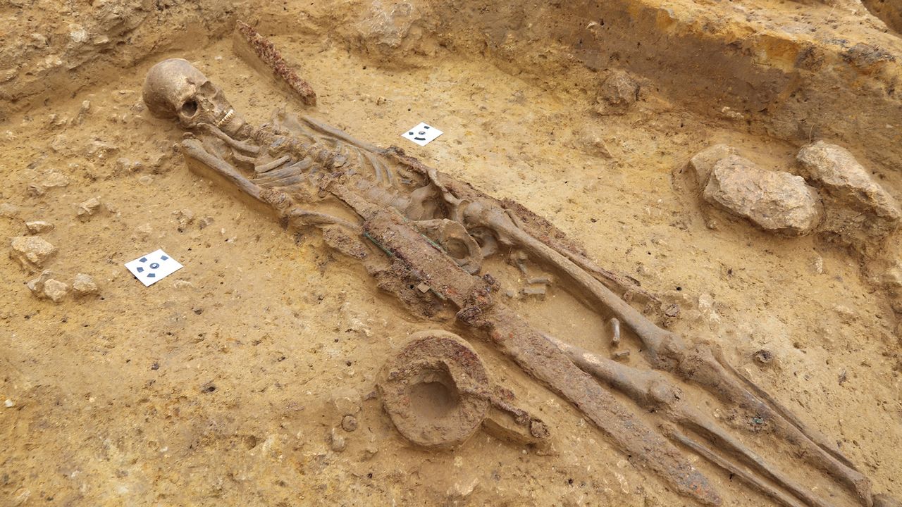 The warrior was buried with four of his weapons, including a long iron sword known as a spatha, and a shield, of which only the metal central parts have survived.