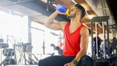 Man drinking pre-workout in the gym