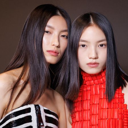 Two models backstage at Balmain fall 2025 show