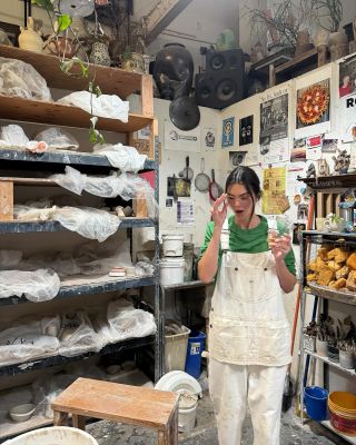 Kendall Jenner attends a pottery class wearing white overalls and a green long-sleeved shirt, updated on Instagram in July 2024