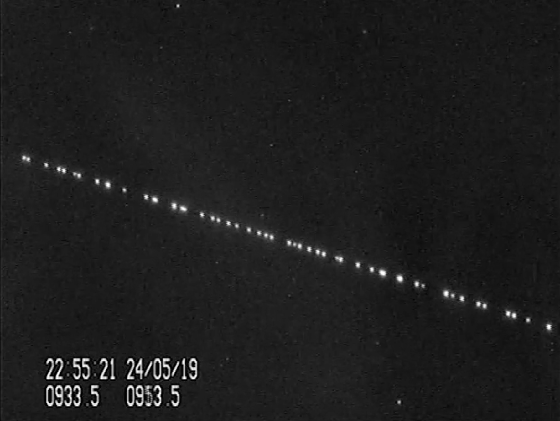 A train of SpaceX Starlink satellites are visible in the night sky in this still from a video captured by satellite tracker Marco Langbroek in Leiden, the Netherlands on May 24, 2019, just one day after SpaceX launched 60 of the Starlink internet communications satellites into orbit.