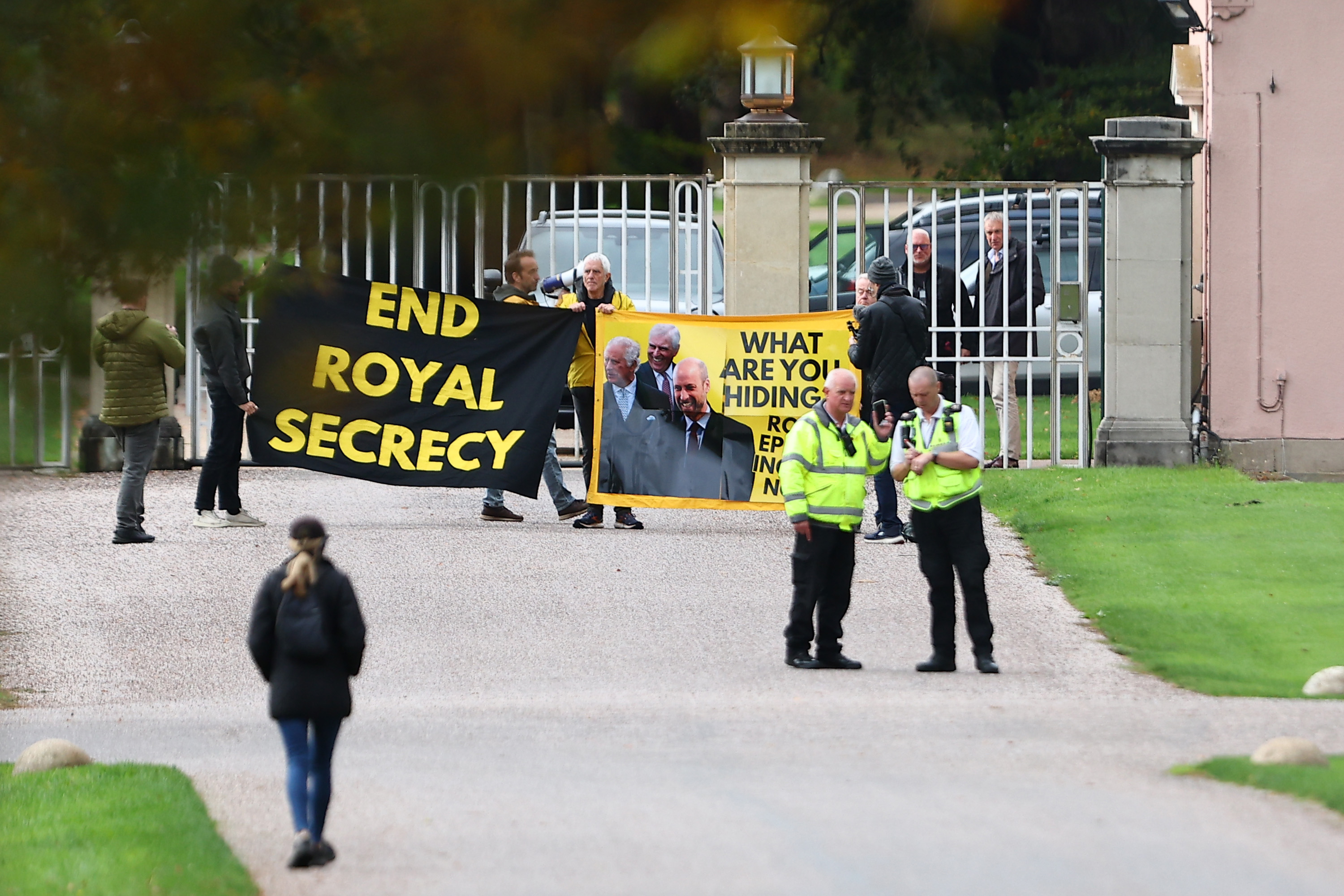 Protestors holding a banner outside Royal Lodge