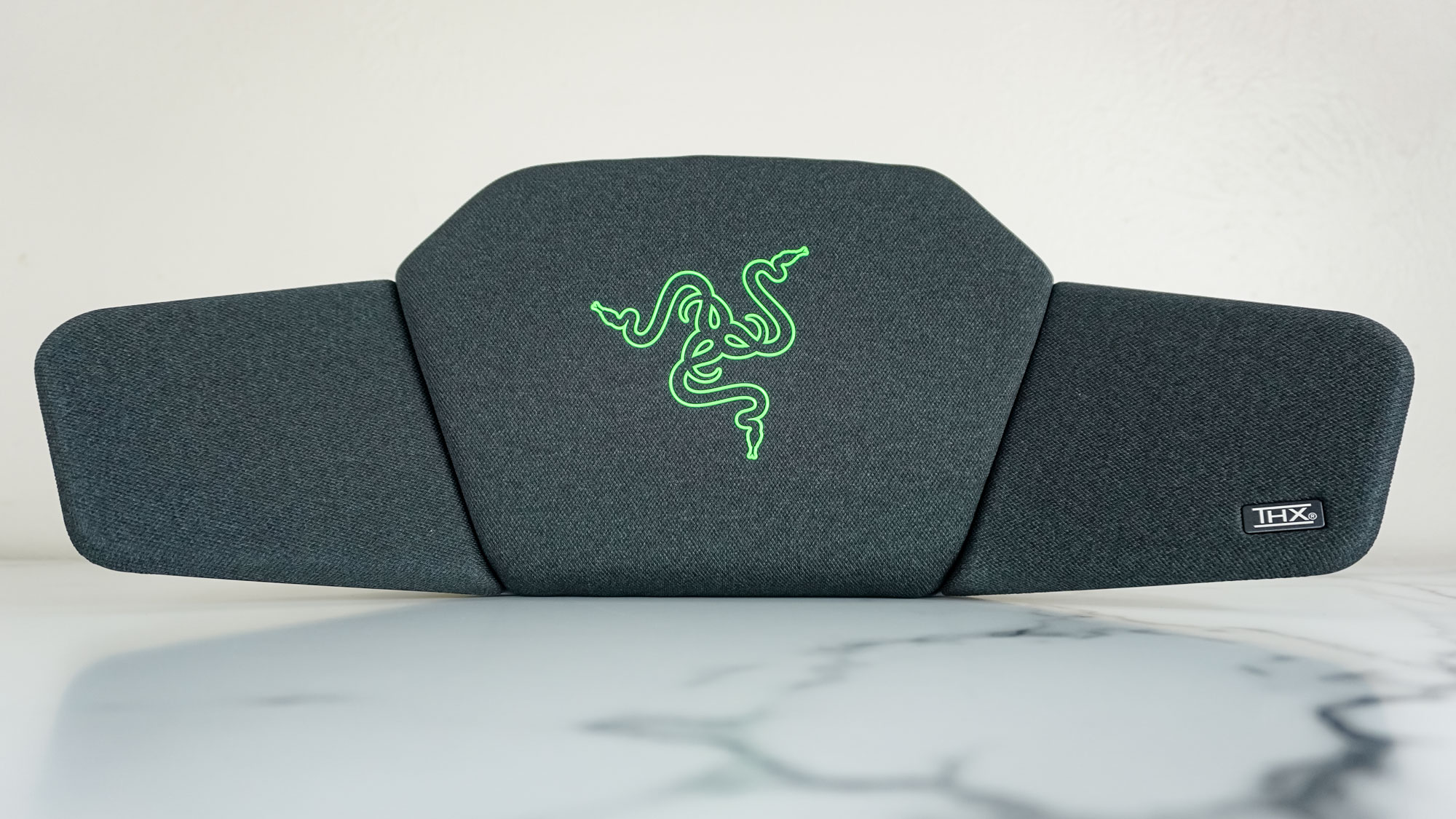 The Razer Clio wireless speaker head cushion on a desk