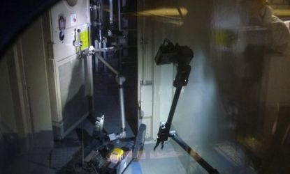 A remote-controlled "PackBot" opens a door in the damaged Fukushima nuclear plant: The robots are made by the same U.S. company that brought us the Roomba vacuum robot.