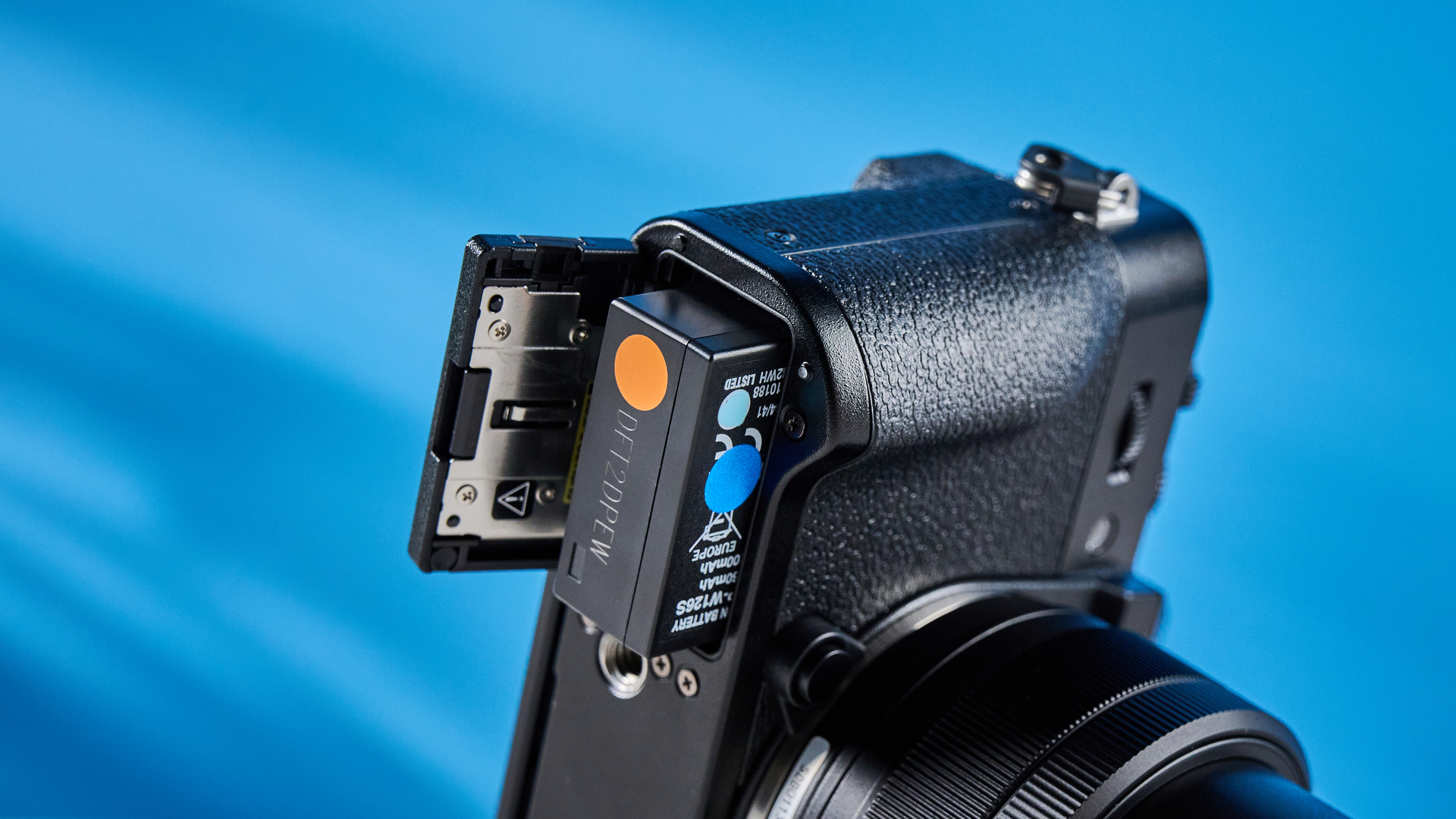 The Fujifilm X-T30 III with its battery partially out of the battery compartment