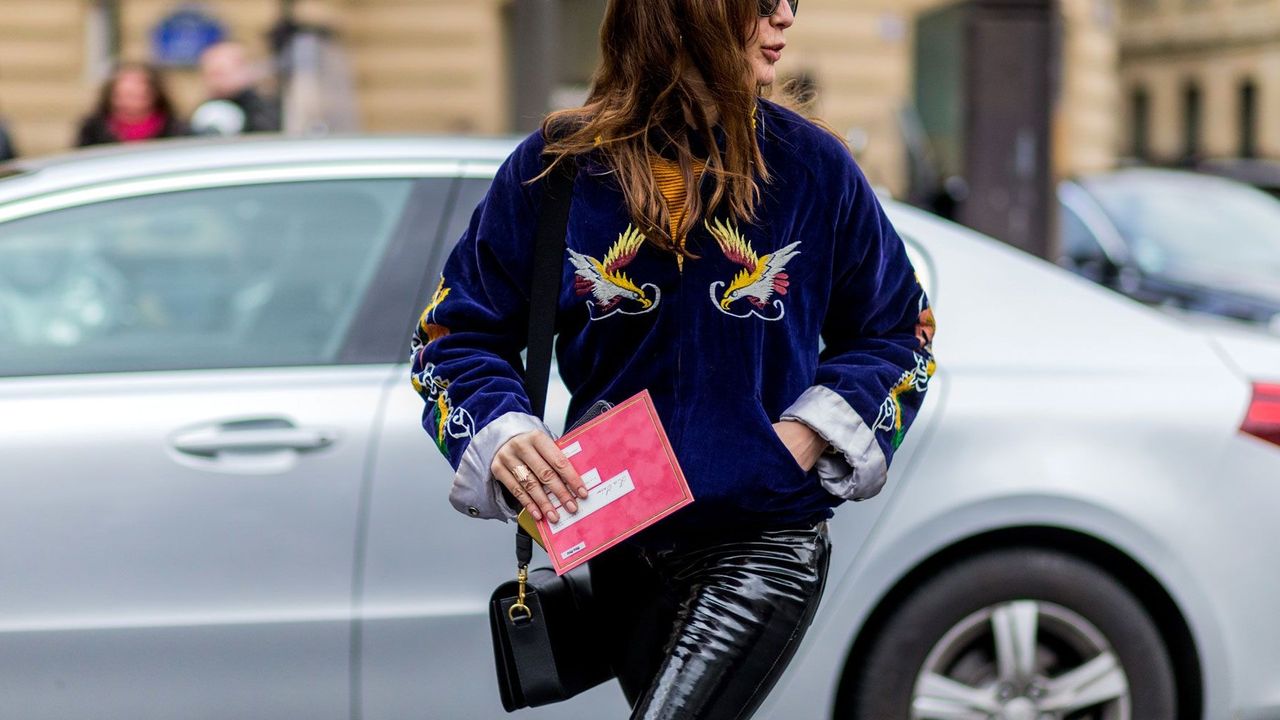 A woman wearing patent leather trousers.