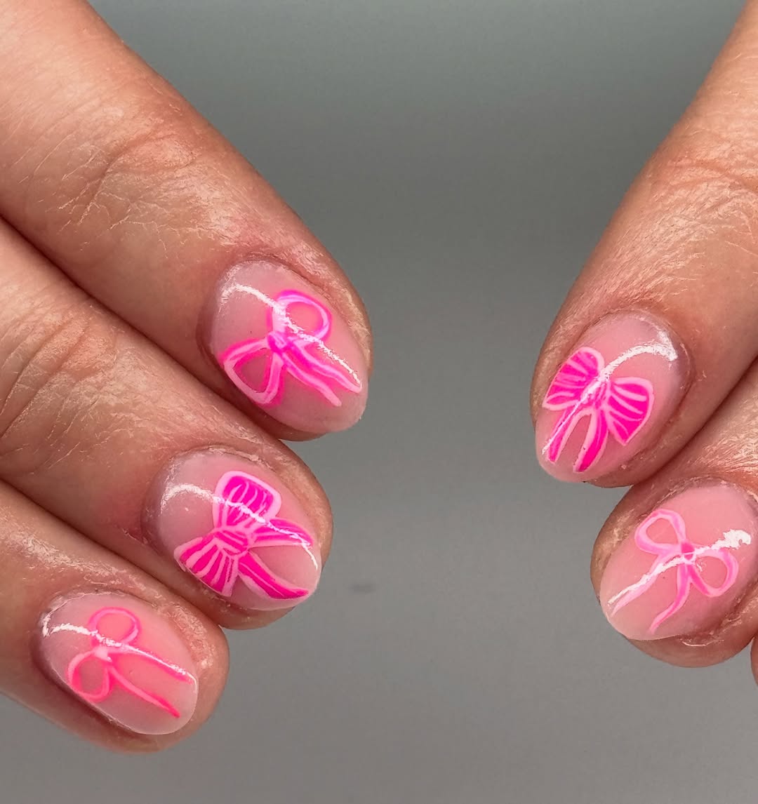 nude nails with pink ribbon designs