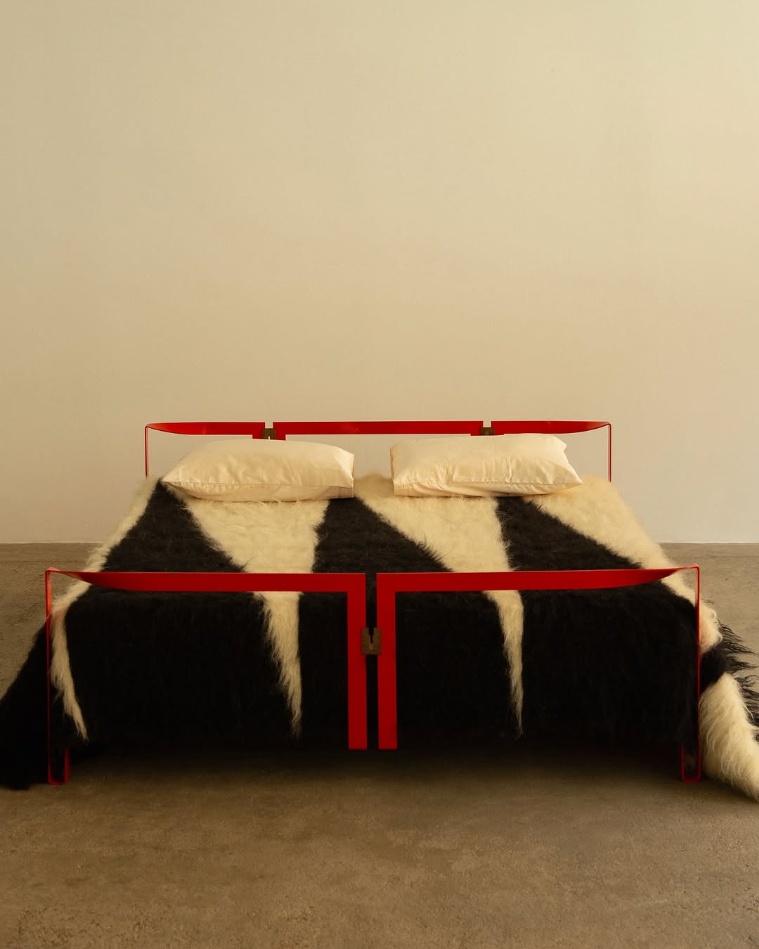 Black and white blanket by Grace Atkinson on red bed