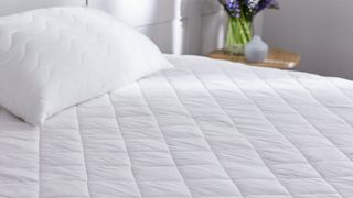 A close up of the Premier Inn mattress protector on the Premier Inn Mattress 2.0 in a hotel room