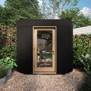 small garden office pod positioned on a gravelled patio