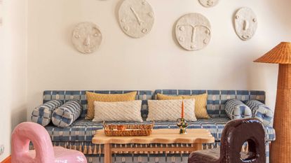 plaster relief faces above a sofa