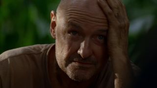 Terry O'Quinn as Locke in Lost, with his hand on his forehead, looking stressed.