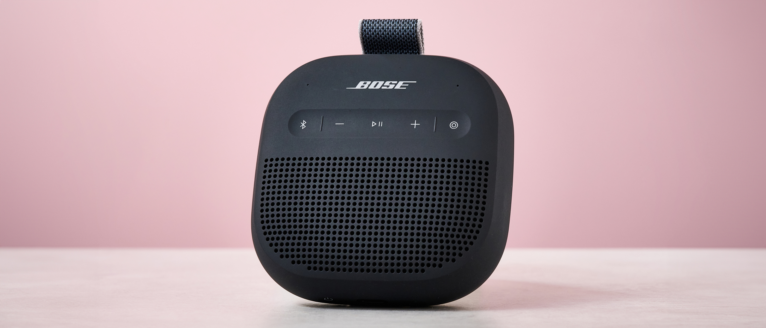 Bose SoundLink Micro Gen 2 on table, against pink background