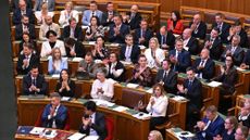 Lawmakers react after voting on an amendment to the constitution by introducing term-limits for prime ministers to a maximum of eight years in office, in the main hall of the Parliament building in Budapest, on June 15, 2026. Hungarian lawmakers on June 15 voted overwhelmingly to limit prime ministers' terms in office to a maximum of eight years, a constitutional change that blocks nationalist Viktor Orban's return. (Photo by Attila KISBENEDEK / AFP via Getty Images)