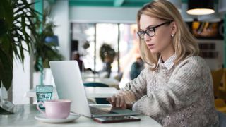 Woman using a laptop in a coffeeshop