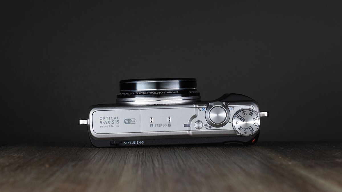 Olympus Stylus SH-3 on a wooden surface