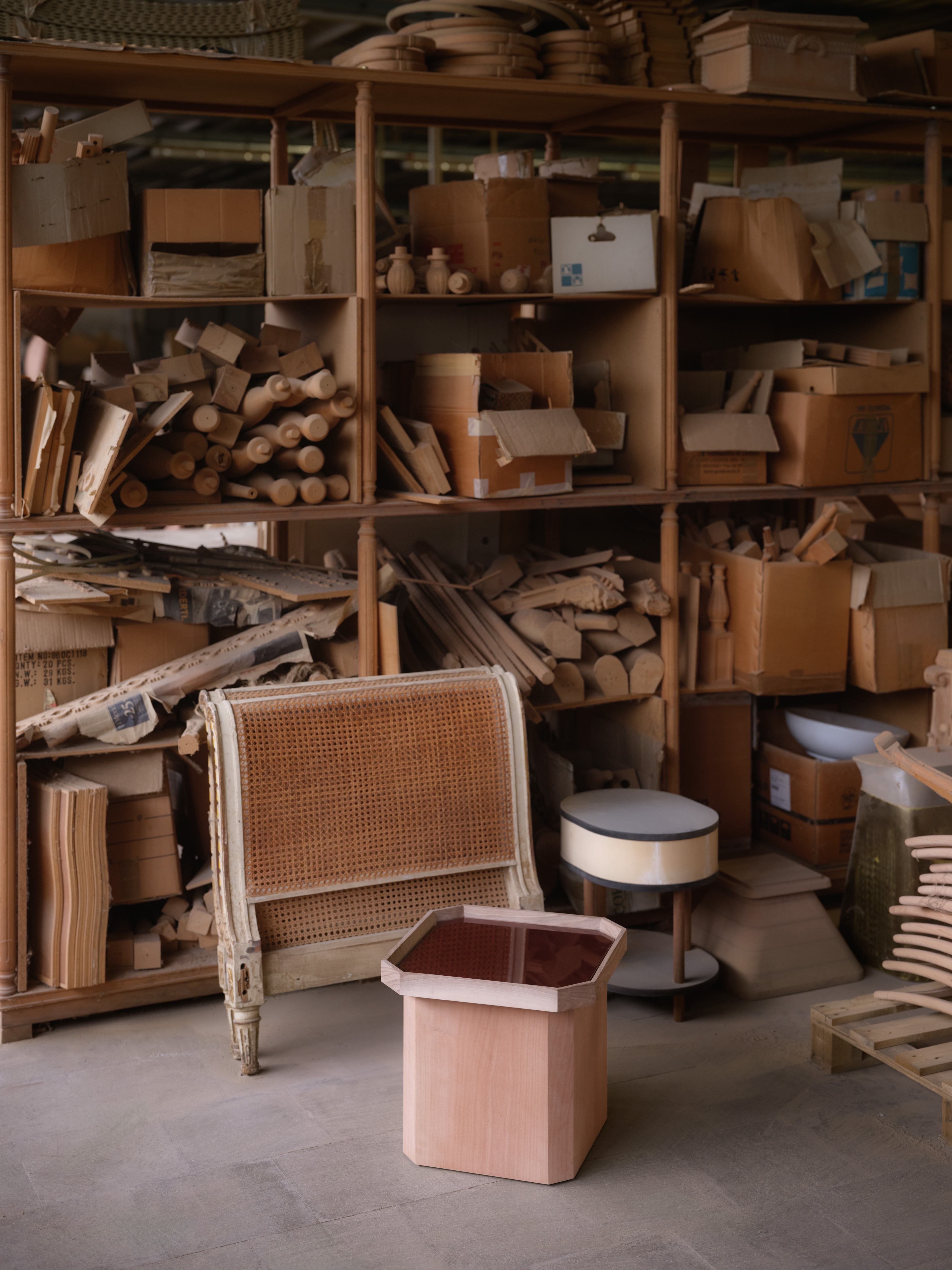 Behind-the-scene shots documenting the project phase and manual elaboration of different artisanal pieces of furniture, set inside a workshop and depicting designers dressed in casual-chic clothing.