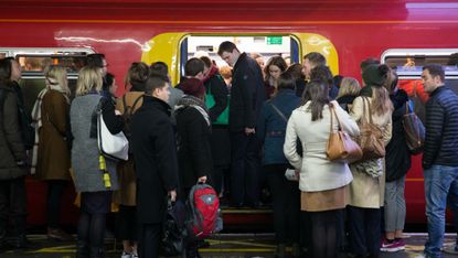 People crowd into a busy train carriage