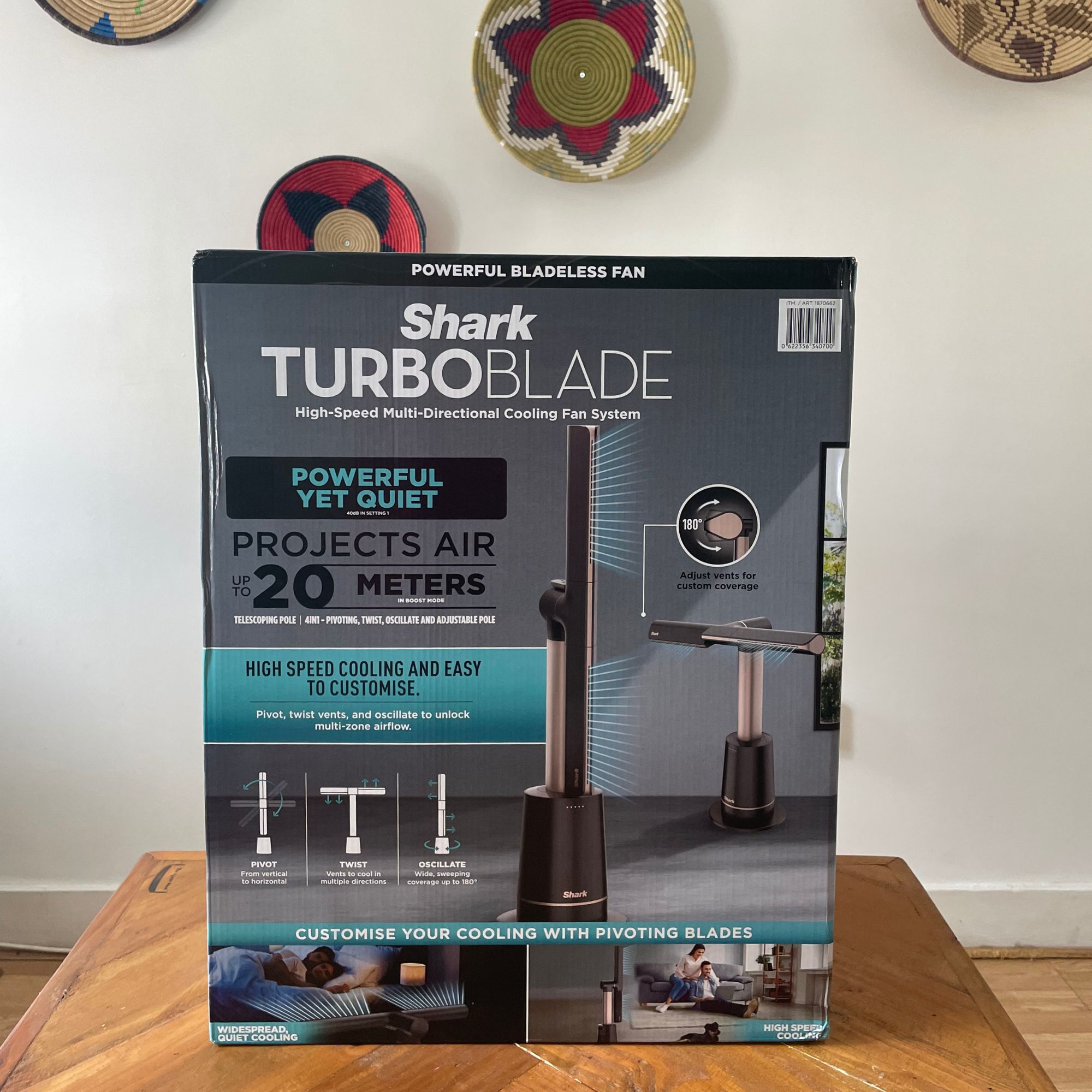 Shark TurboBlade fan sitting on a wooden table in front of a white wall