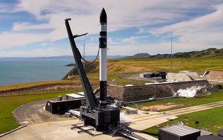 A Rocket Lab Electron booster stands on the pad ahead of the planned Dec. 15, 2020, launch of a mission called "The Owl's Night Begins."