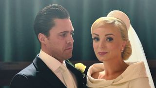 Helen George as Trxie Franklin and Olly Rix as Matthew Aylward on their wedding day wearing a wedding dress and suit in Call the Midwife season 12 finale