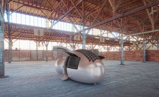 Ecocapsule inside an empty warehouse