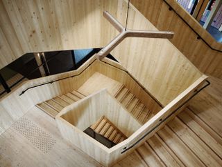 An impressive cascading central staircase and bespoke furniture