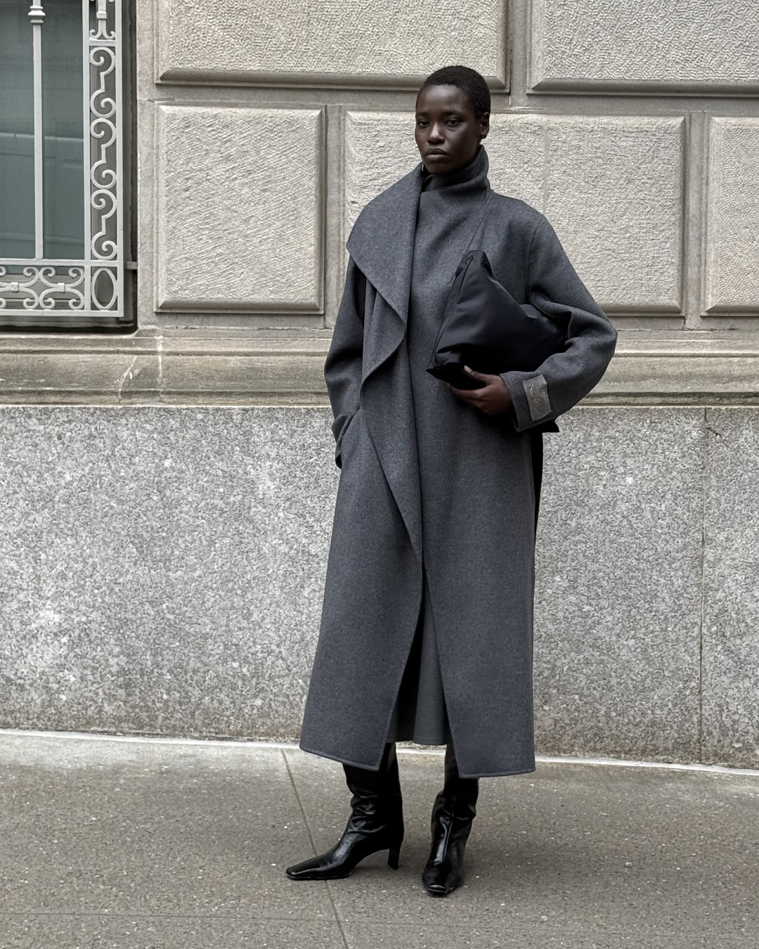 Aritzia model wearing a gray funnel-neck coat.