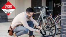 Image shows a man locking up his bike.