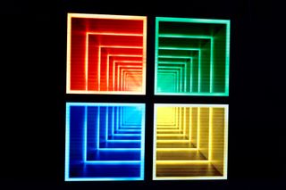 Microsoft logo, containing endless boxes of color within each of the four colored sqaures that make up the logo against a dark background, to form a 'tunnel' effect