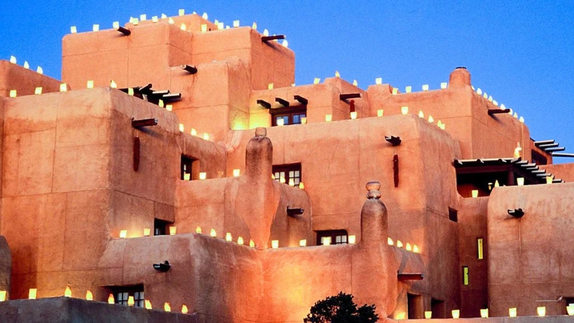 Pueblo-Style Loretto Hotel Christmas Farolito At Dusk