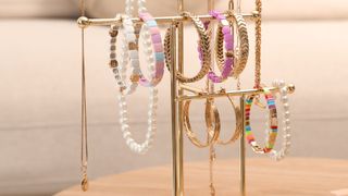 gold jewellery stand with bracelets and necklaces