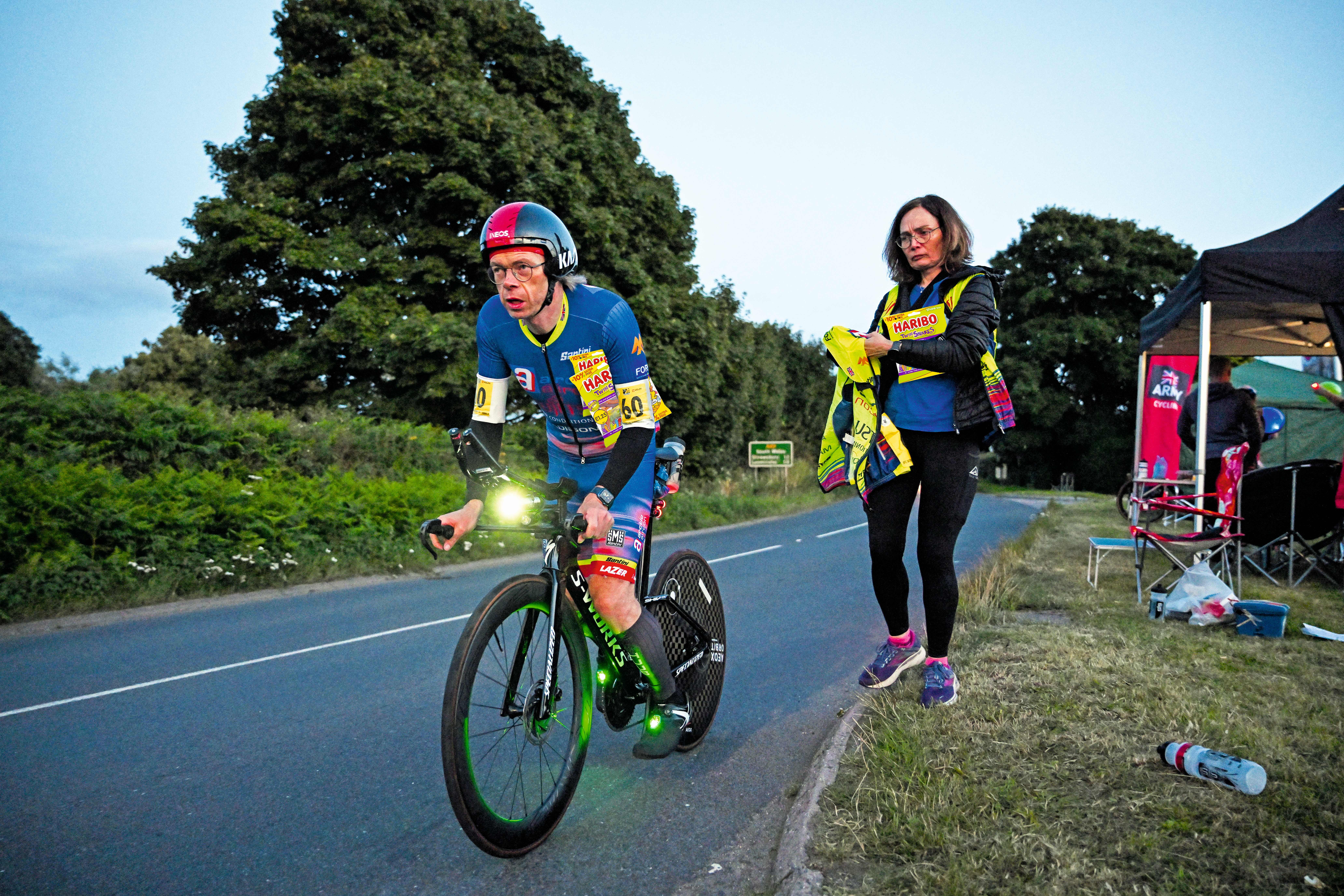 Dr Hutch cycles along a road at night