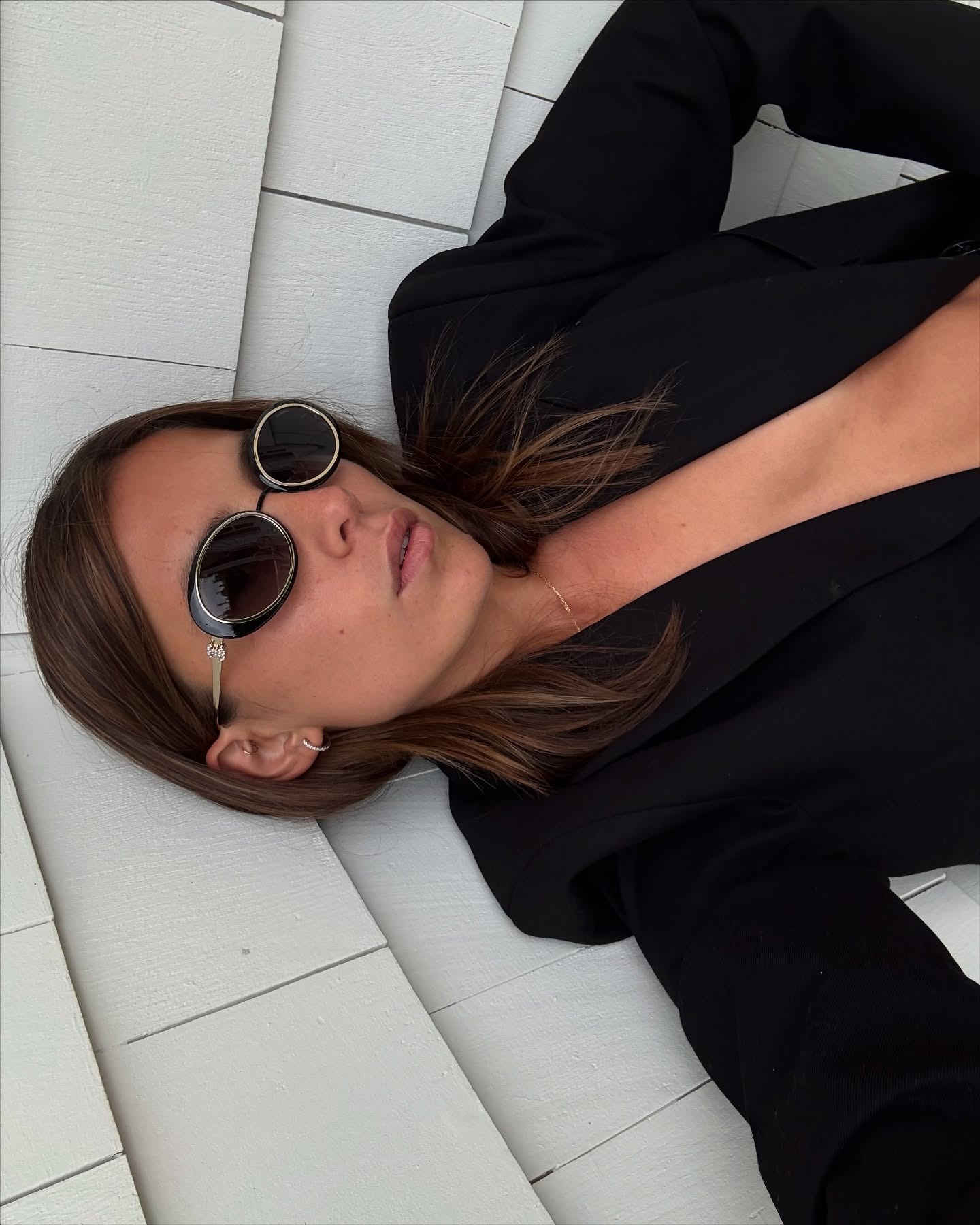 Woman wearing an outfit with Chanel sunglasses.