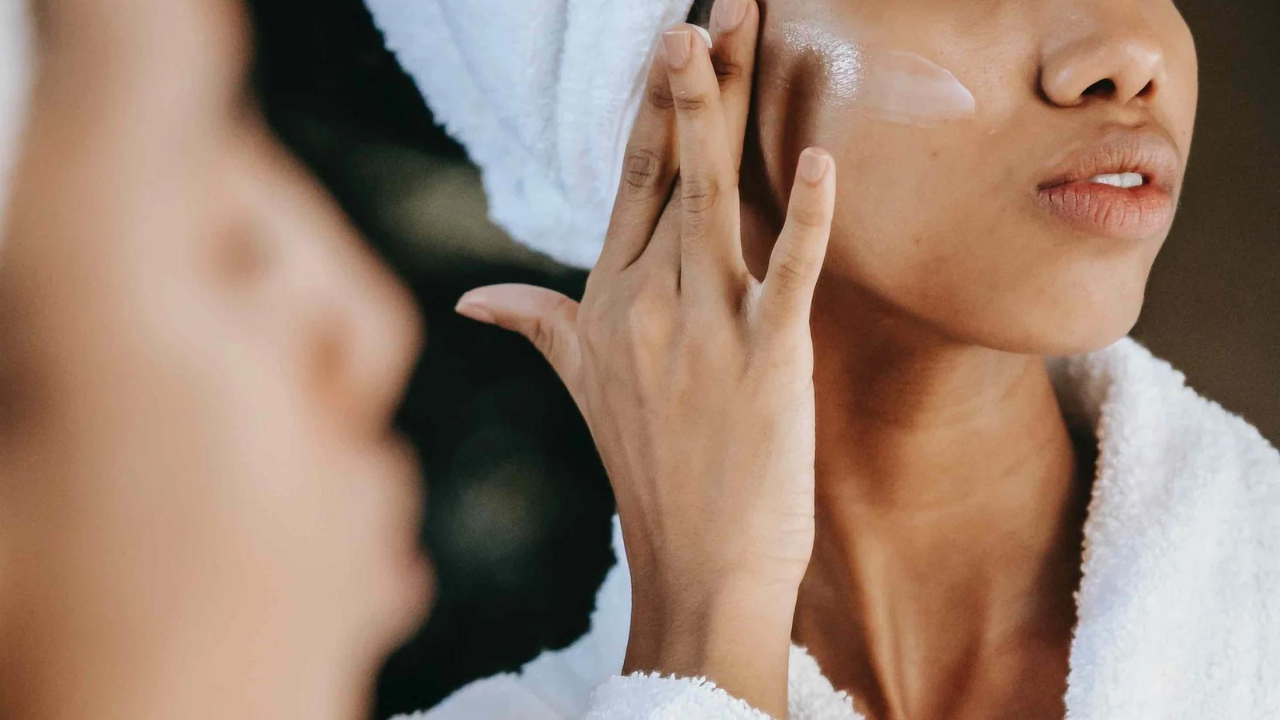 Woman applying skincare in bathroom