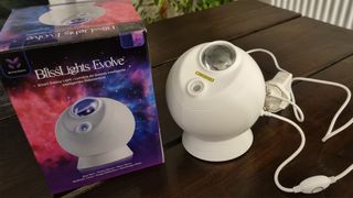 The BlissLights Sky Lite Evolve on a table next to it's packaging and cable now on sale during amazon prime day